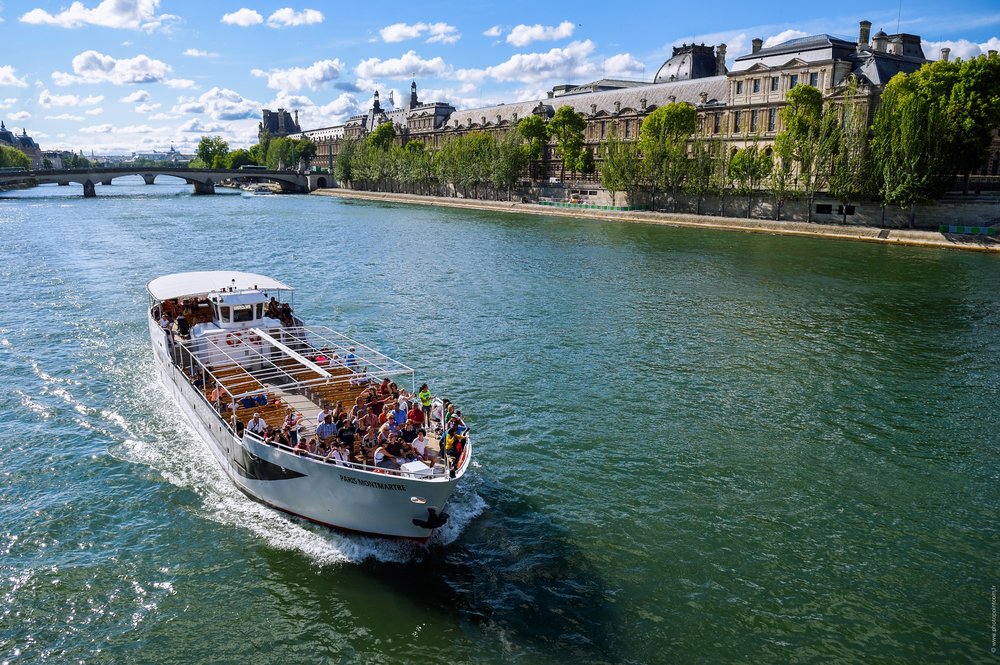 people enjoying champagne and snacks at the river seine tour in paris
