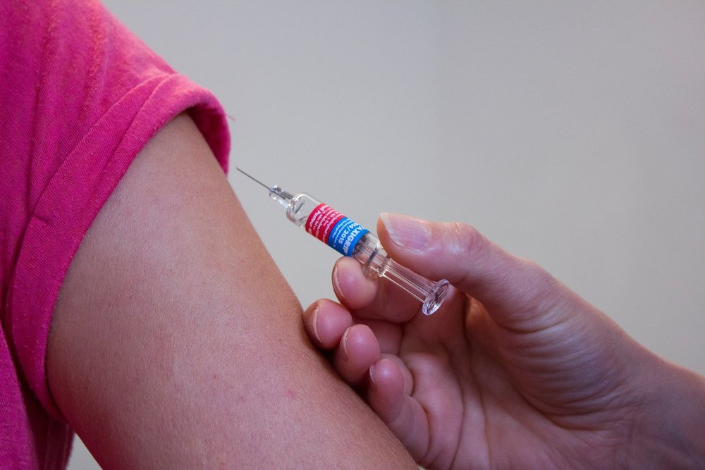 woman getting a COVID-19 vaccine jab