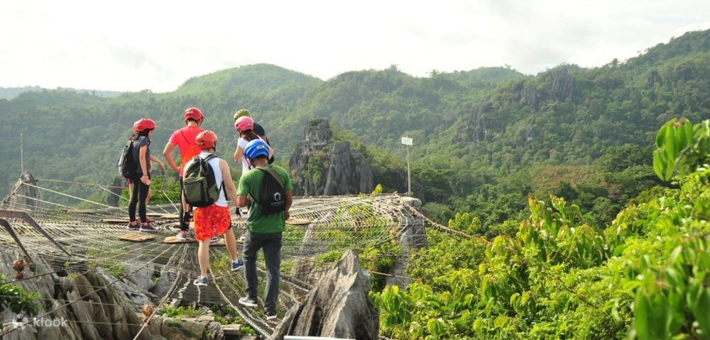 travelers standing on web set on top of mountains