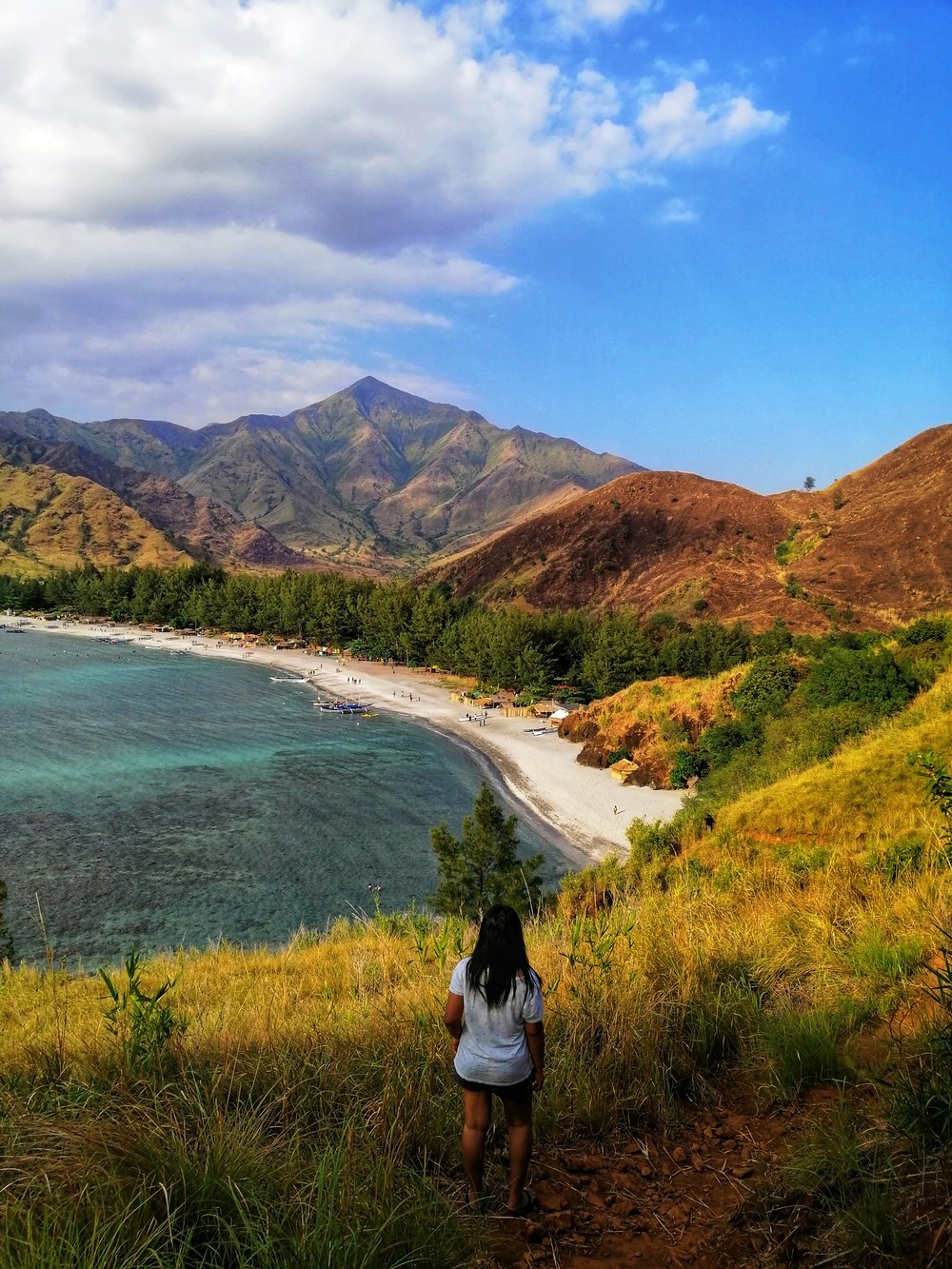 girl by hill looking at cove
