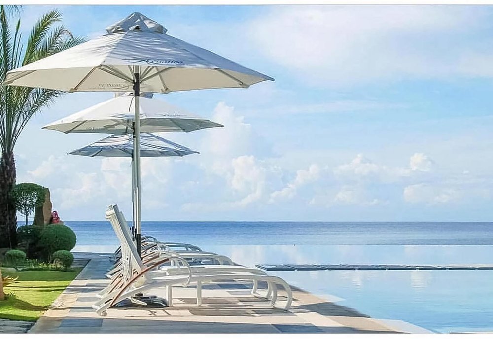 white beach bed by infinity pool