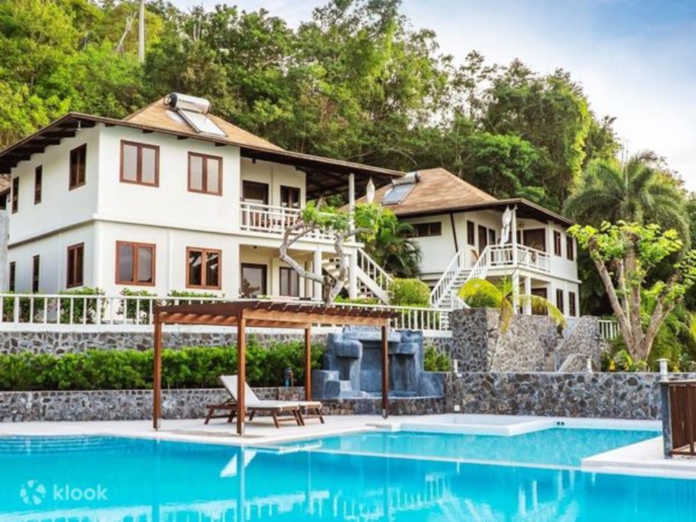 three storey white beach resort by pool