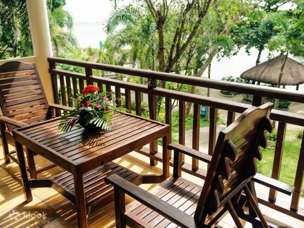 wooden table and chairs by balcony