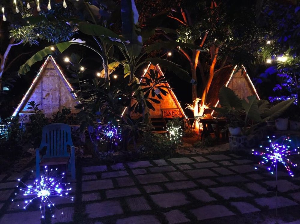 glamping villas lit with colorful lights