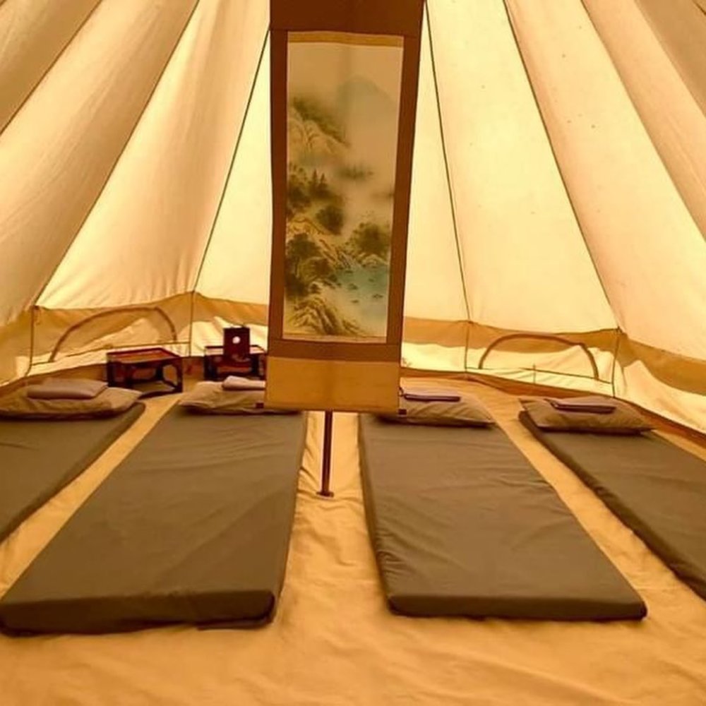 gray mattresses inside lit tent