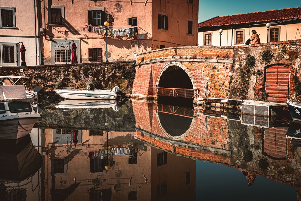a woman walking around livorno italy