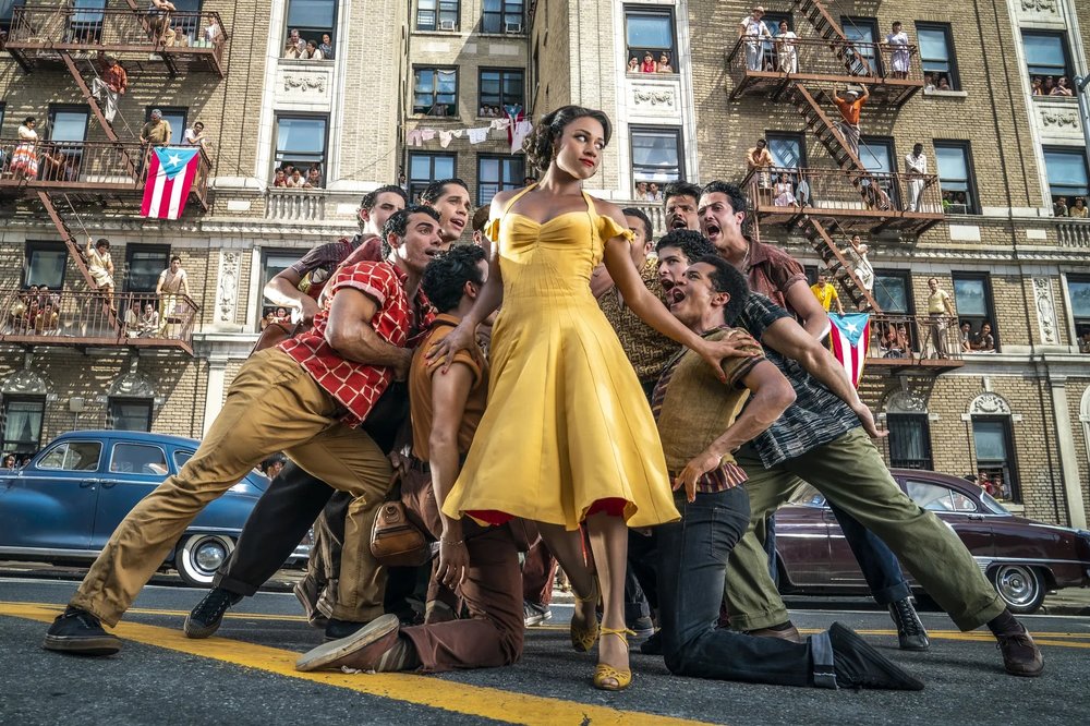 men surrounding a girl in a yellow dress
