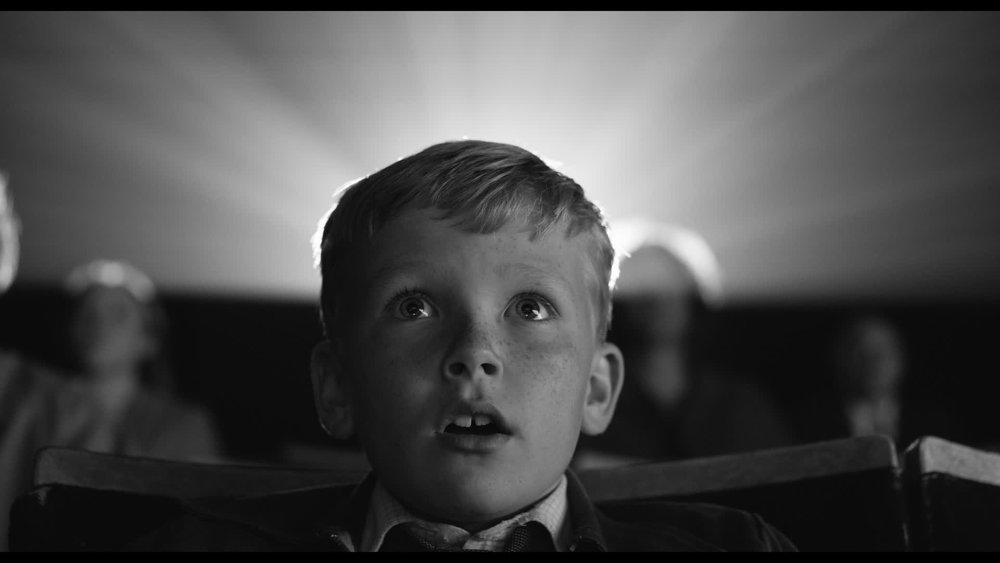 still in black and white of a boy watching a movie