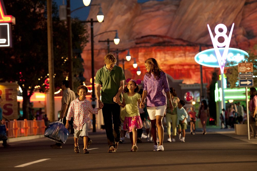 family of four enjoying disneyland california at night