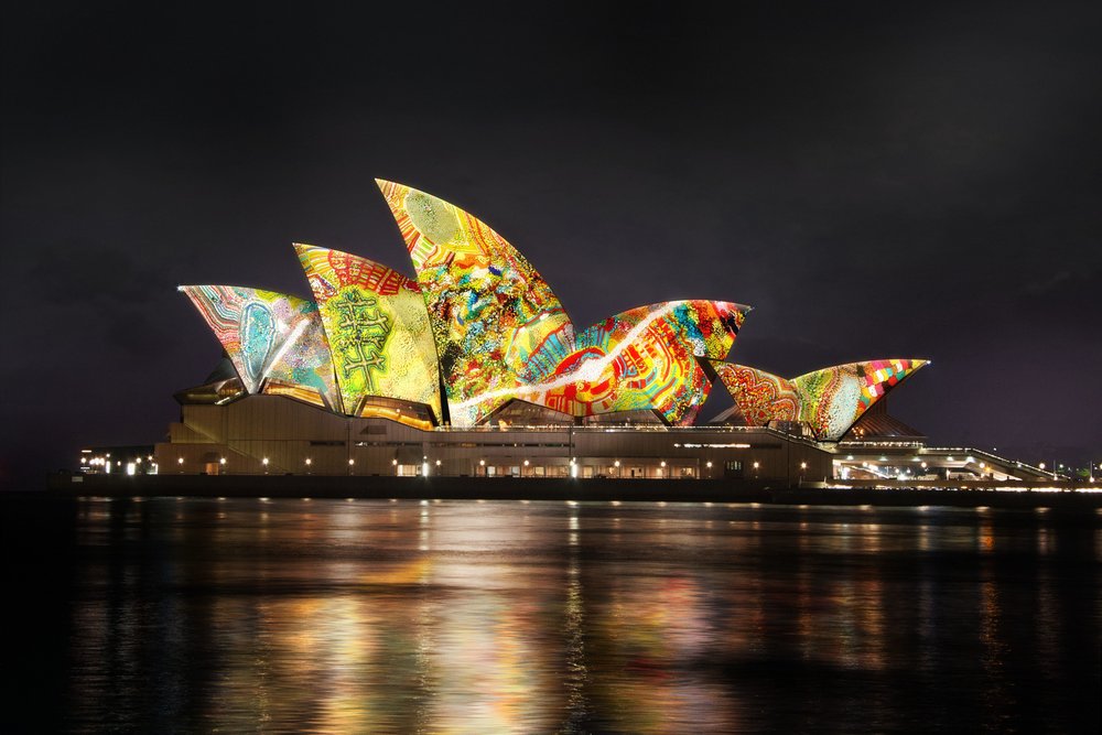 Learn about Aboriginal intimate connection to the land with the Sydney Opera House as its canvas. Image credits:'Yarrkalpa - Hunting Ground, 2021' Artists Impression by Martu Artists and Curiious with soundtrack by Electric Fields and Martu Artists