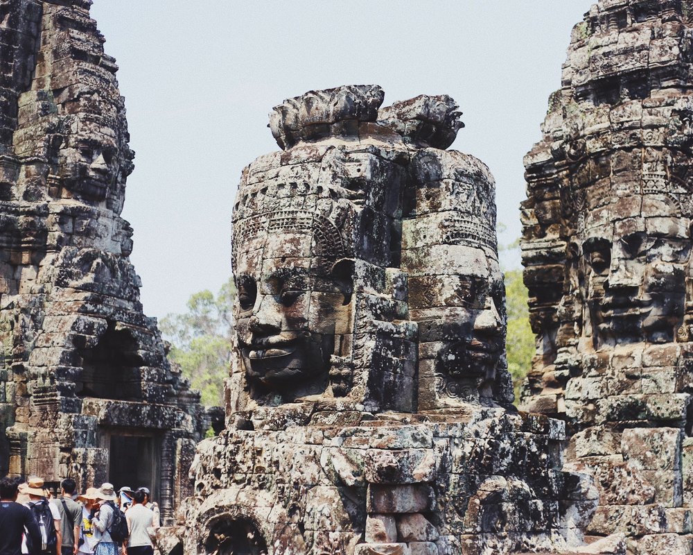 Tourists visiting the smiling faces of Bayon Temple