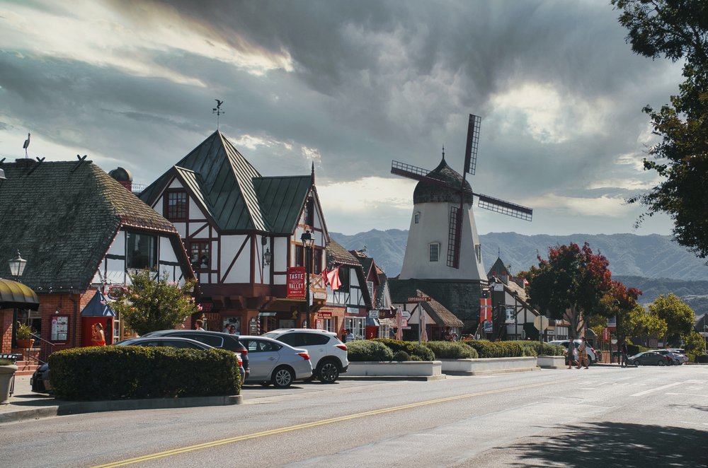 a street in solvang california with a view of a windmill