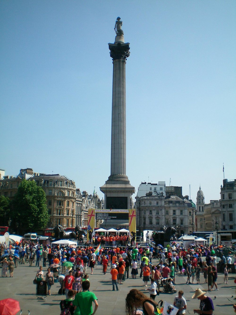 a crowd gathers in front of nelson's column in trafalgar square london england