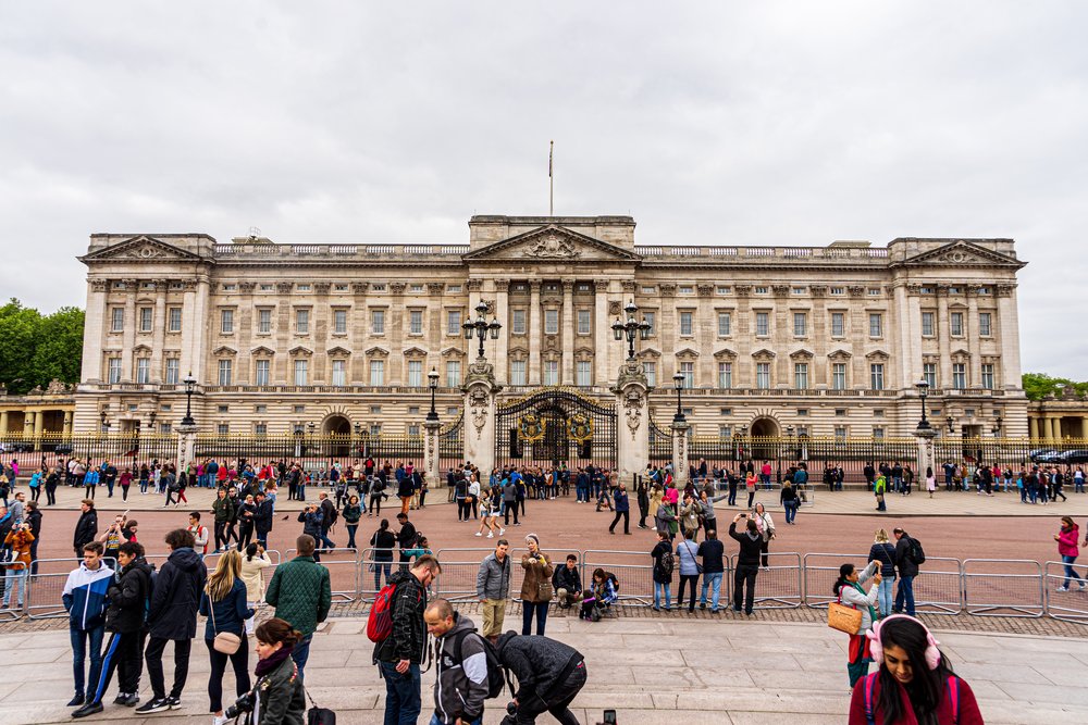 tourists gathering in front of buckingham palace london uk