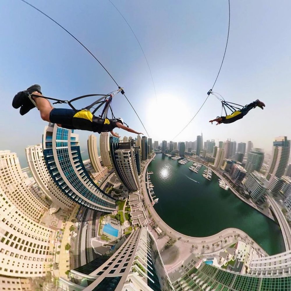 2 men riding zipline