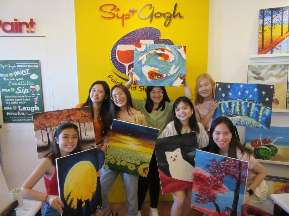 Group of friends holding their canvas