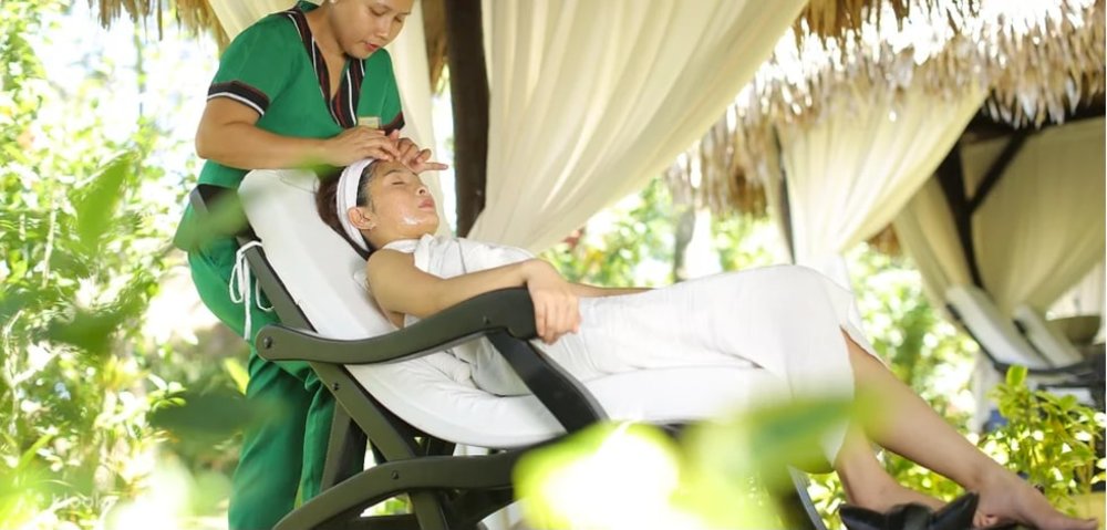 women receiving facial massage in chair