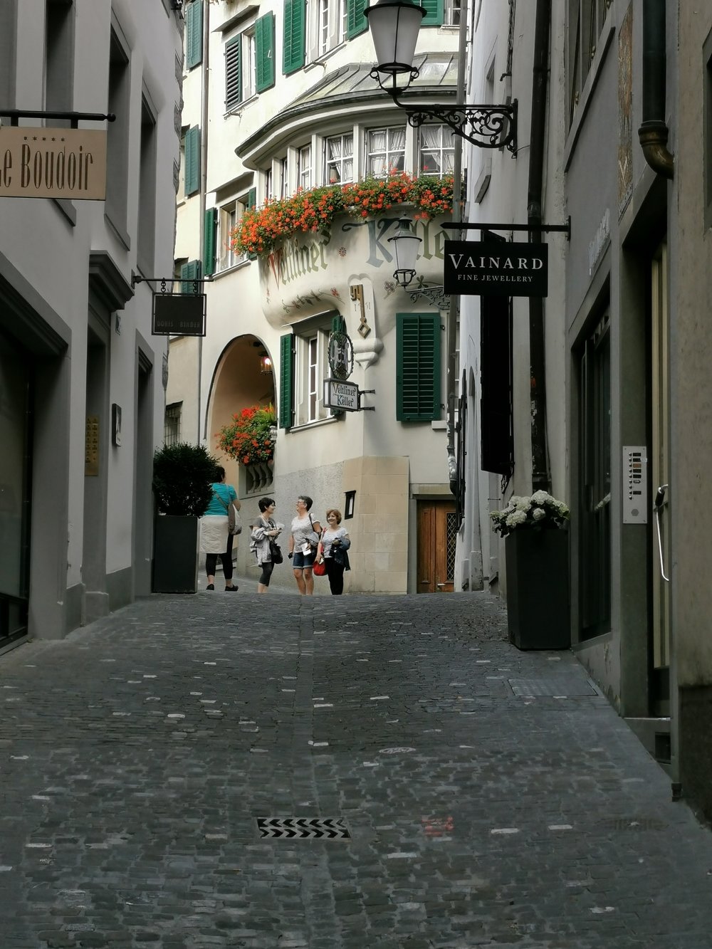 a group of women walking down the street at zurich old town switzerland