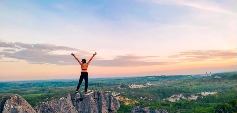Girl standing on top of mountain