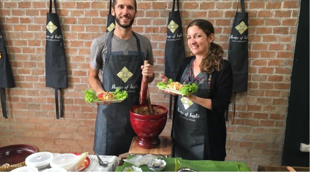 Two cooks showing of their dish