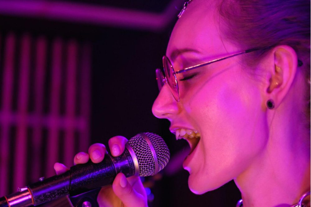Girl with glasses singing