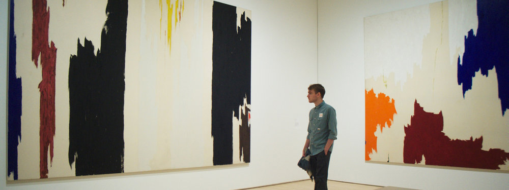 man looking at painting in san francisco museum of modern art