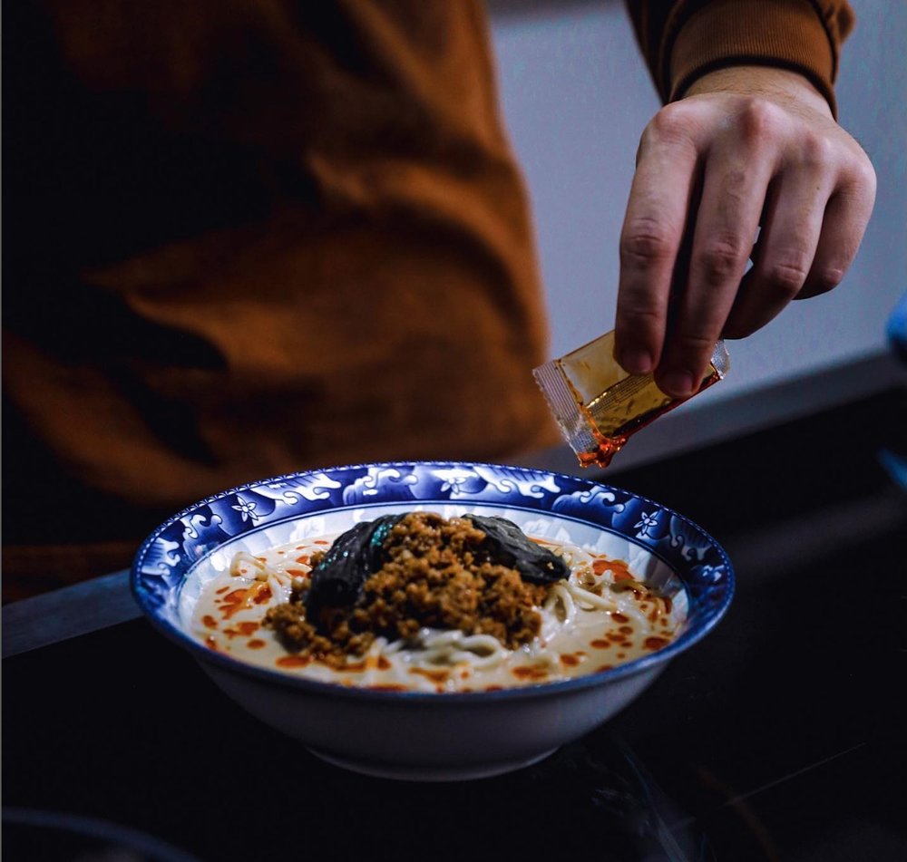 Chef putting chili oil in ramen