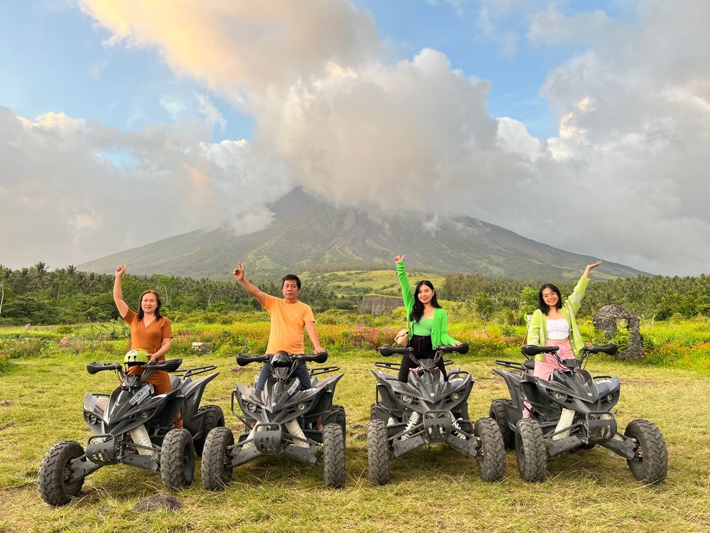 Family riding ATV with the view of Mountain