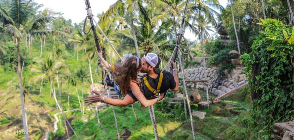 Couple kissing while in the swing
