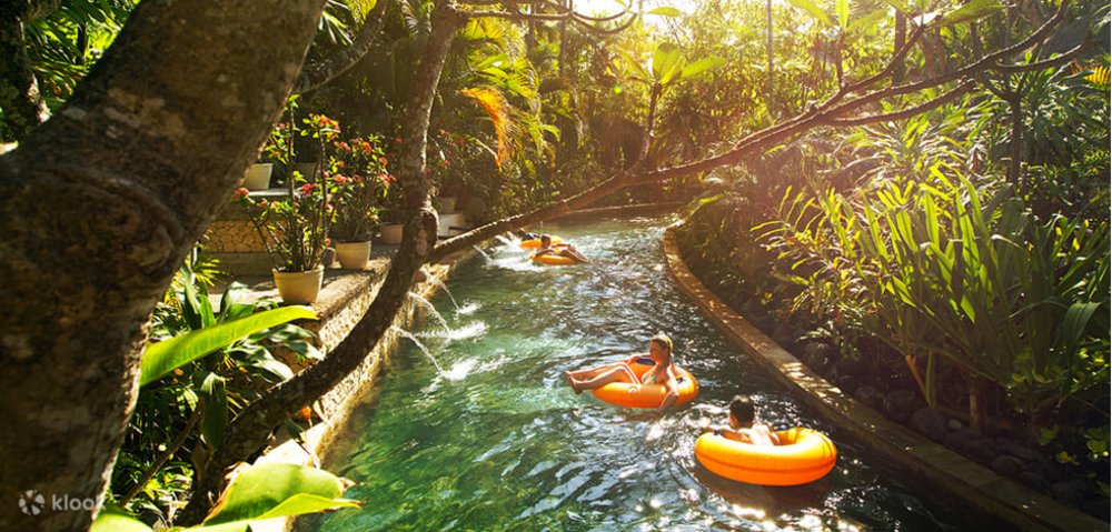 Group of friends riding a floater in a pool