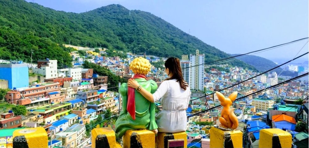Woman sitting to watch the colorful houses in Gamcheon