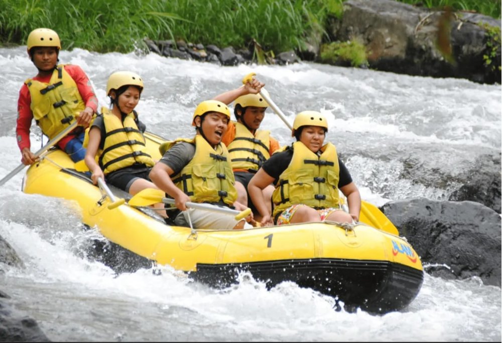 Group of friends having fun in river rafting