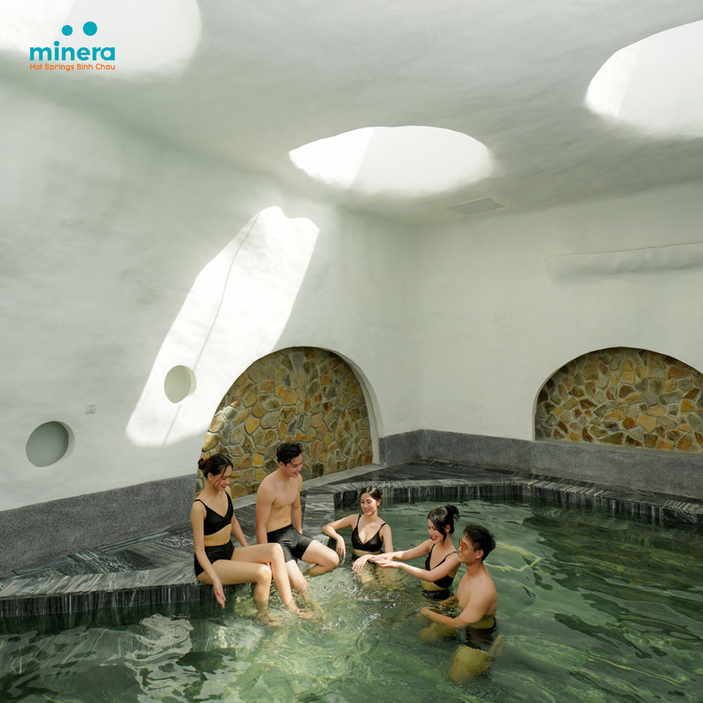 Group of people bathing in a man made spring