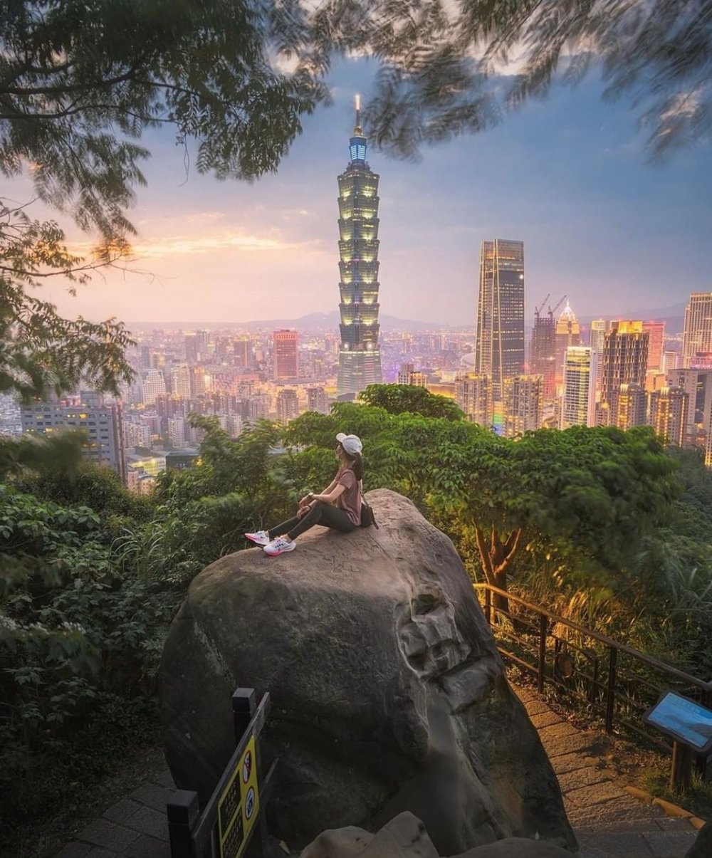 Women sitting in a elephant like stone