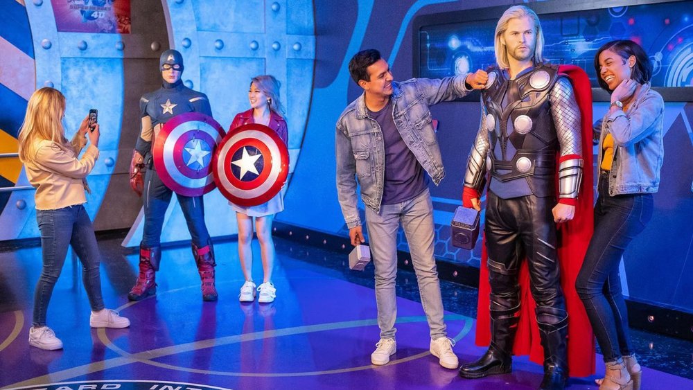 Visitors posing for photos with different wax figures