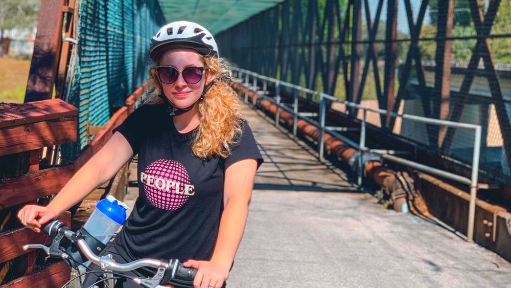 Girl posing for a photo while on her bike on West Orange Trail
