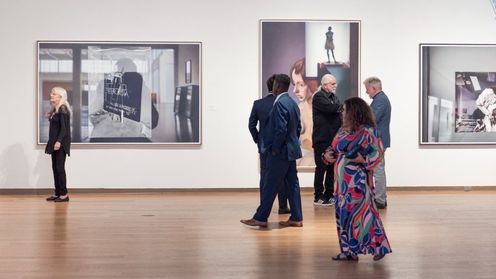 Visitors looking at different art pieces at Orlando Museum of Art