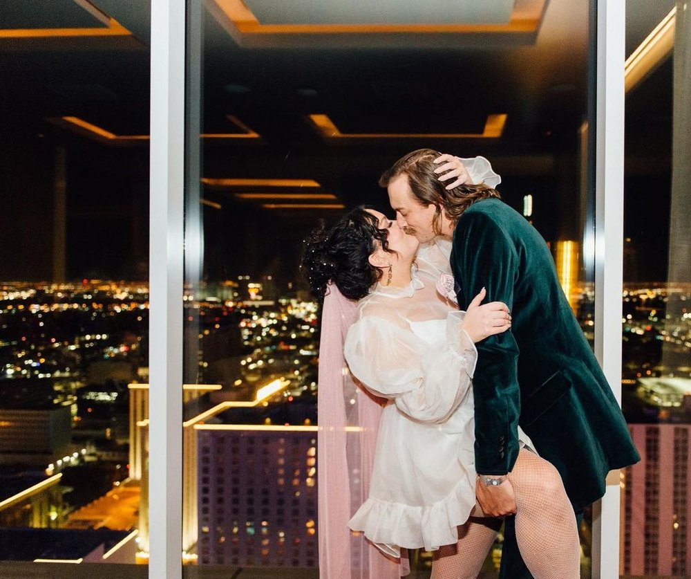a couple kissing in a rooftop bar