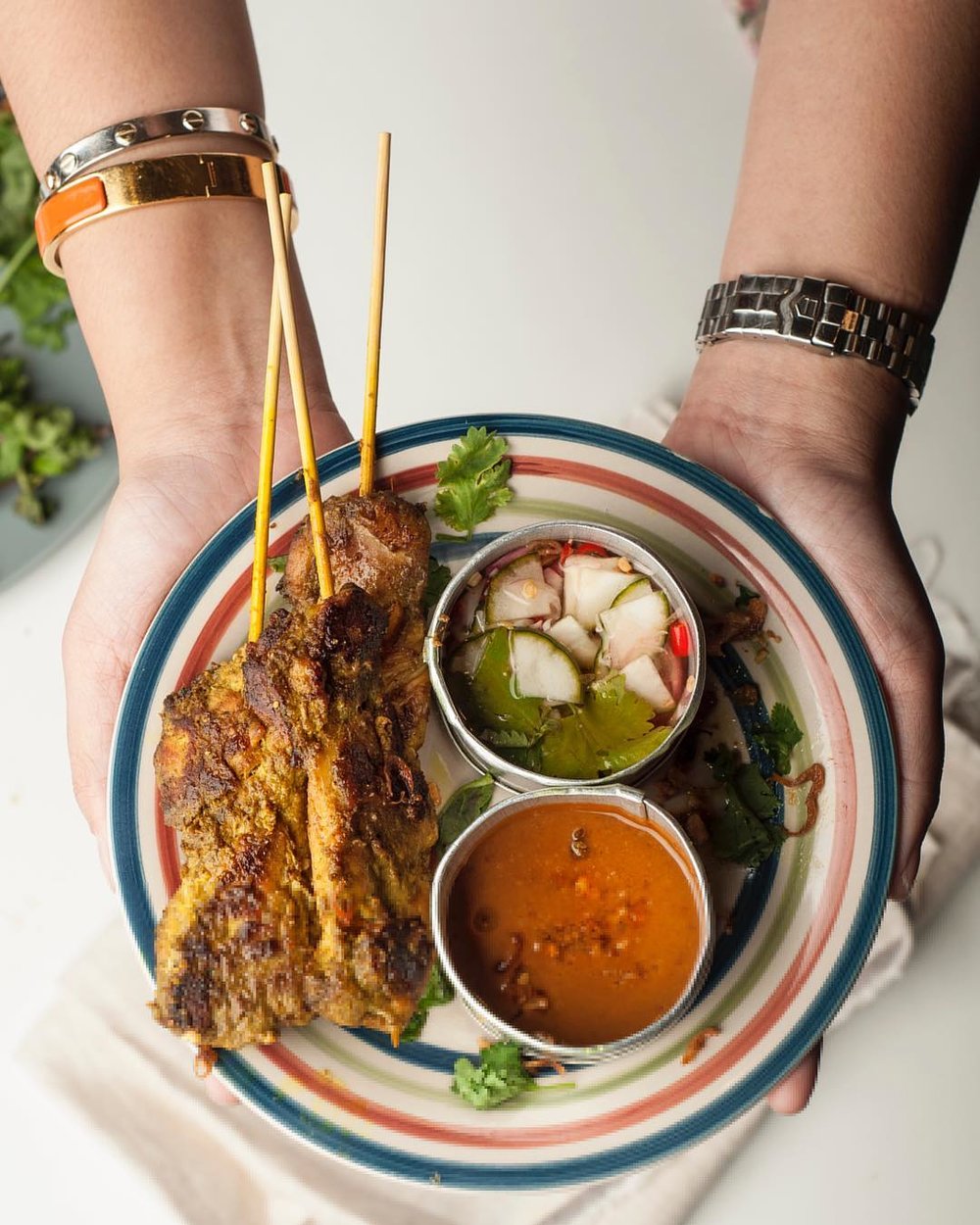 holding a bowl of thai soup