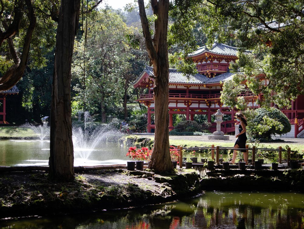 Woman walking in front of Byodo-In Temple 