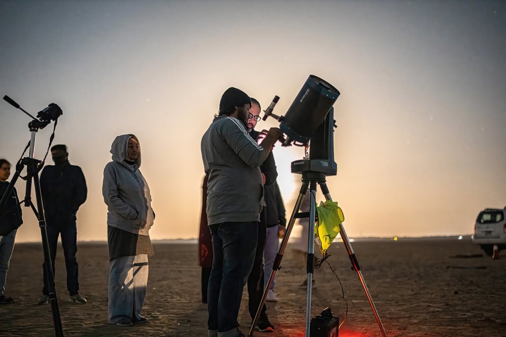 A group of people stargazing in the desert