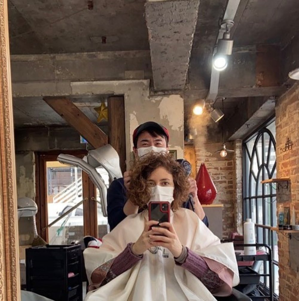 Hairdresser and client looking in the mirro