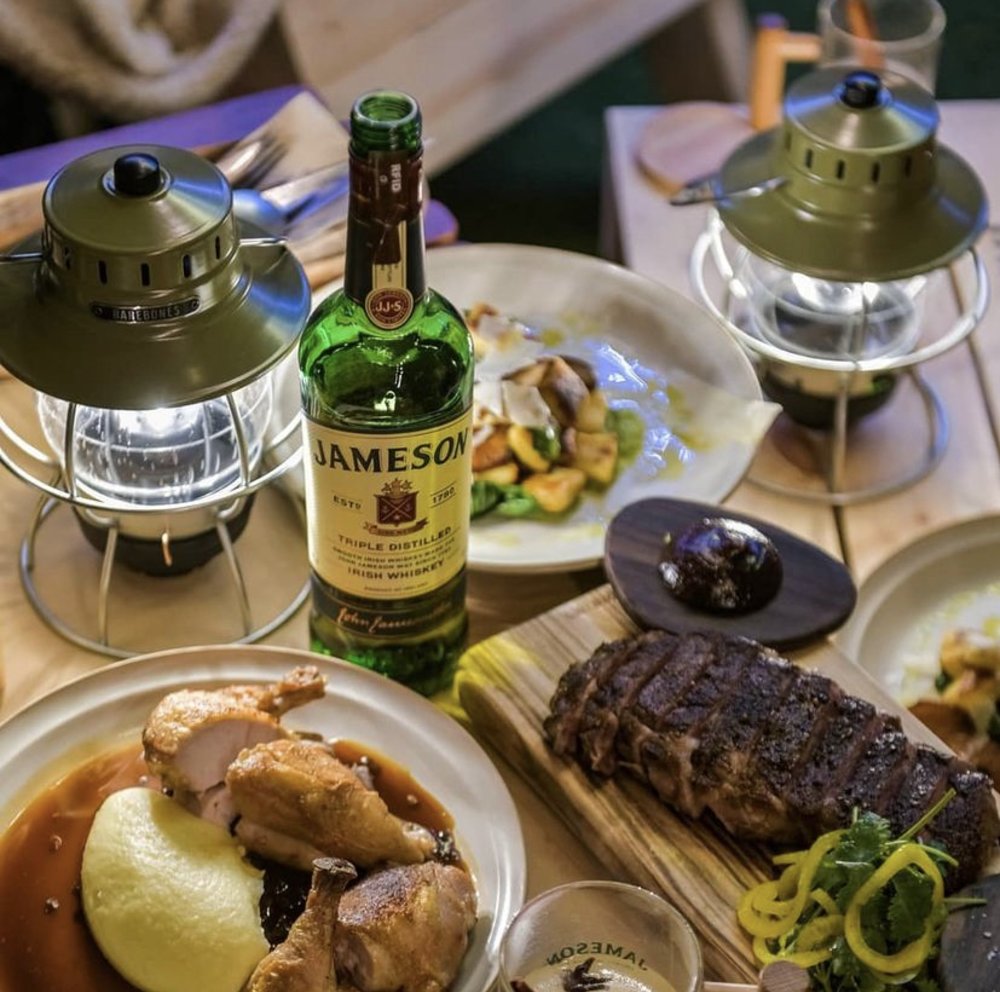 Chicken dish and steak in table