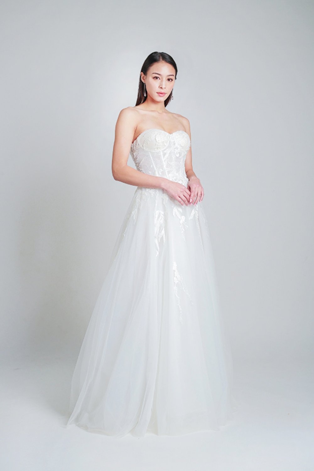 Girl posing while wearing a wedding gowns