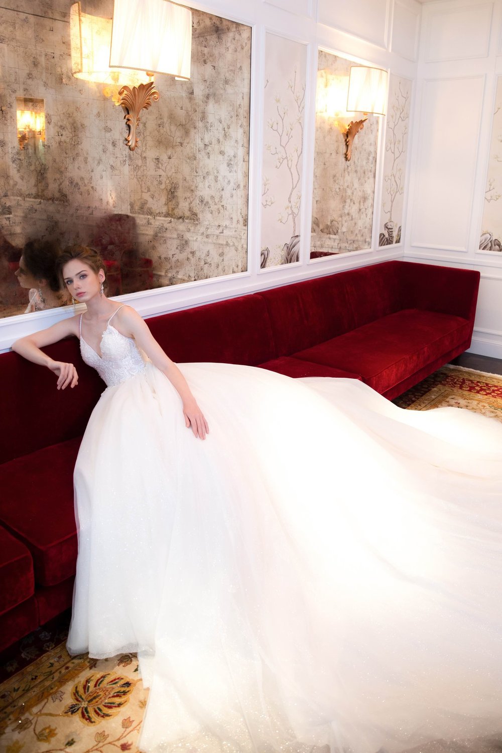 Bride sitting in a red sofa