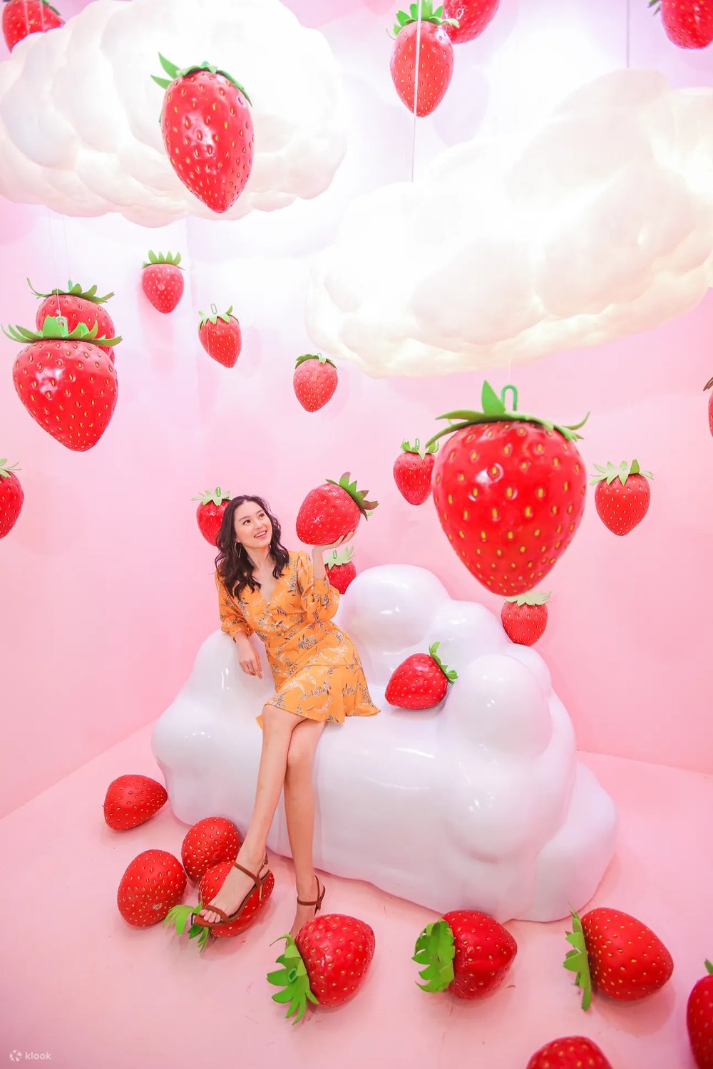 Girl posing in a strawberry filled attraction