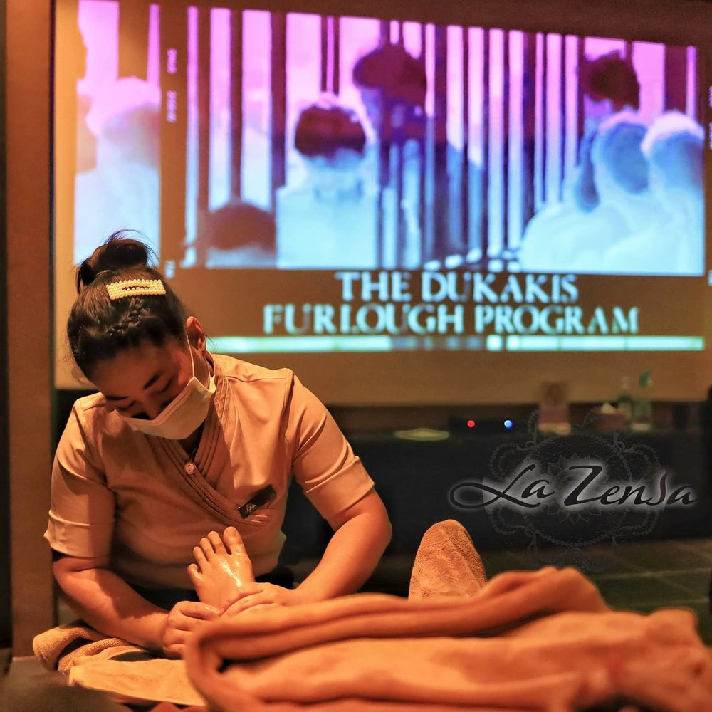 Watching a movie while having a foot massage