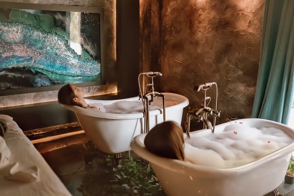 Two friends having a bubble bath