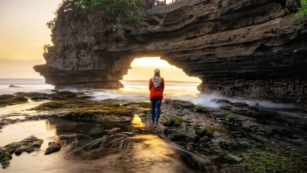 Tanah Lot, which means land and sea in English, is one of the finest places to watch the sunset. Credit: sandal_gunung_