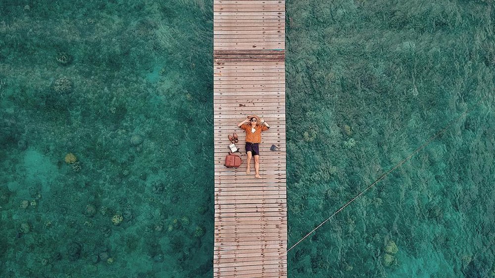 Check out the wooden bridge, take in the fresh ocean air, and enjoy the tranquil vibe. Credit: wijayya_